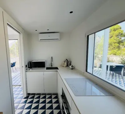 a kitchen with a counter top and a window at Marina Boutique Rooms in Carini