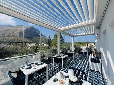a restaurant with a view of a mountain at Marina Boutique Rooms in Carini