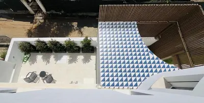 a building with a blue and white checkered ramp at Marina Boutique Rooms in Carini