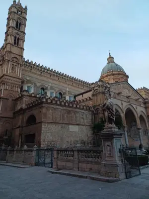 a building with a clock tower and a statue at Difronte Palatina Chapel in Palermo