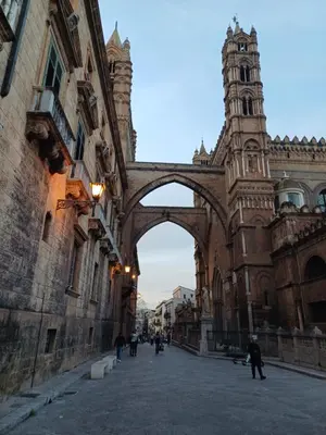 an archway in a building with a clock tower at Difronte Palatina Chapel in Palermo