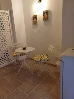 a kitchen with a table and two chairs and a table at Difronte Palatina Chapel in Palermo