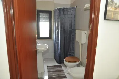 a bathroom with a toilet and a sink at La Via Del Mare in Partinico