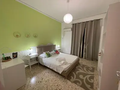 a bedroom with green walls and a bed and a desk at Casa dei nonni di Yuri in Palermo