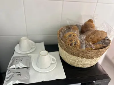 a basket of bread and cups on a table at Casa dei nonni di Yuri in Palermo