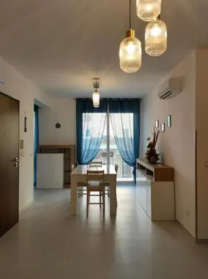 a dining room with a table and a window at Casa3Fratelli, via Cutino 16 in Isola delle Femmine