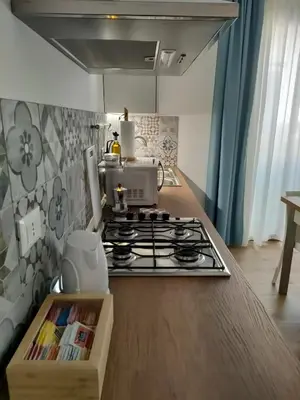a kitchen with a stove top oven in a kitchen at DH Studio Apartments in Castellammare del Golfo