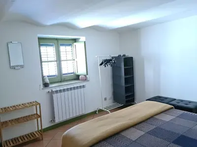 a bedroom with a bed and a window and a radiator at Casa e Putia Apartment in Palermo
