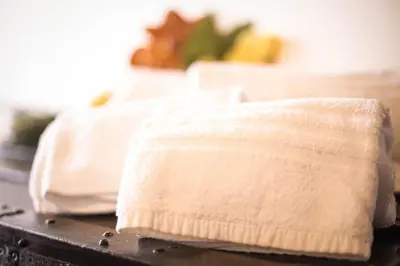 two white towels sitting on top of a table at Appartamento Le Terrazze in Castellammare del Golfo