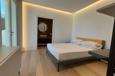 a bedroom with a bed and a sink and a mirror at Villa Ippolita - 2 Bedrooms Apartment with Exclusive Garden in San Vito lo Capo
