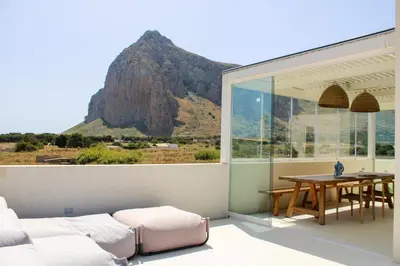 a balcony with a table and a view of a mountain at Villa Ippolita - 2 Bedrooms Apartment with Terrace & Garden Exclusive in San Vito lo Capo
