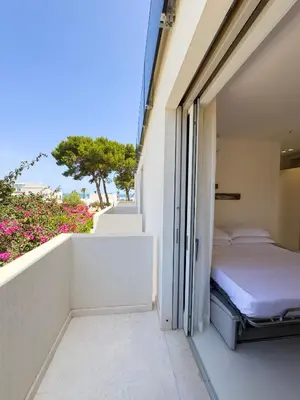 a bedroom with a bed on a balcony at Villa Ippolita - 2 Bedrooms Apartment with Terrace & Garden Exclusive in San Vito lo Capo