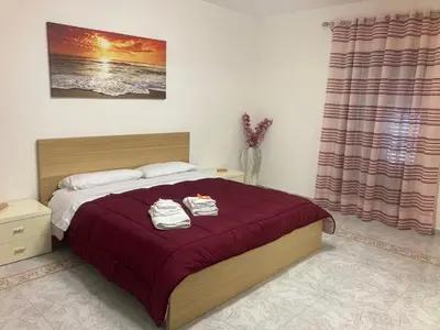 a bedroom with a bed with two towels on it at Casa Paradiso in Palazzo Adriano