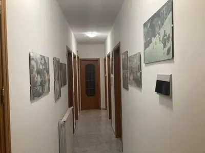 a hallway with a bunch of pictures on the wall at Casa Paradiso in Palazzo Adriano