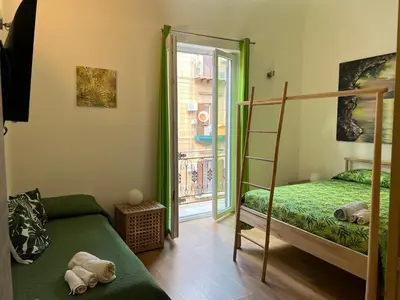 a bedroom with a bunk bed and a ladder at Ricasoli28Apartaments in Palermo