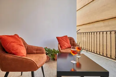 two chairs and a table with two glasses of wine at Zia Marì Casa Vacanze in Palermo