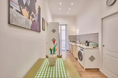 a kitchen with a table with a green and white at Zia Marì Casa Vacanze in Palermo