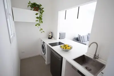 a kitchen with a sink and a washing machine at iFlat Porta di Mare 45 in Palermo