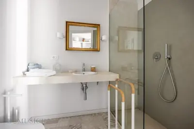 a bathroom with a sink and a shower at Palazzo Fatta Apartment by DomuSicily in Palermo
