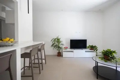 a kitchen with a table and chairs and a television at iFlat Porta di Mare 49 in Palermo