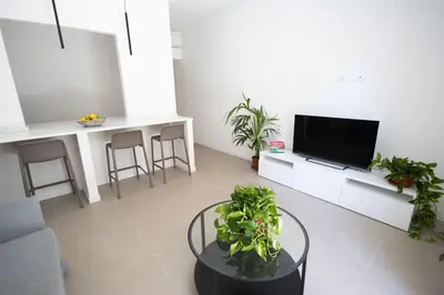 a living room with a tv and some plants at iFlat Porta di Mare 49 in Palermo