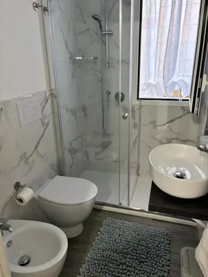 a bathroom with a shower and a toilet and a sink at Casalabruto in Bagheria