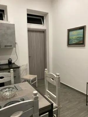 a living room with a table and chairs at Casalabruto in Bagheria