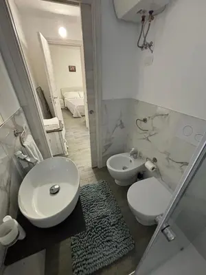 a bathroom with a toilet and a bidet and a sink at Casalabruto in Bagheria