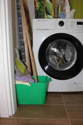 a washing machine with a green bucket next to it at Zia Pina Home in Palermo