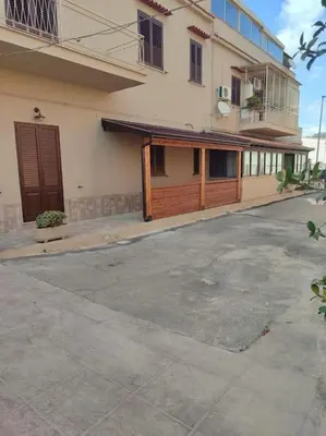 an empty parking lot in front of a building at Zia Pina Home in Palermo