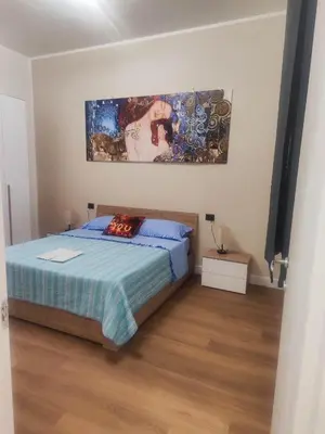 a bedroom with a bed and a painting on the wall at Casa Donna Caterina e Don Paolo in Bagheria