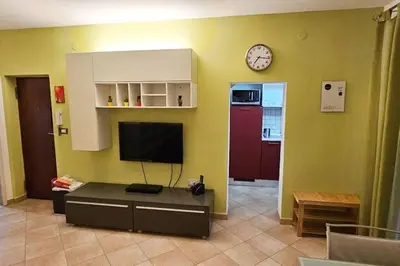 a living room with a tv and a clock on the wall at Cappellieri Home in Palermo