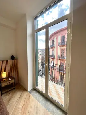 a room with a large window with a view of a building at LB SilvioCentro in Palermo