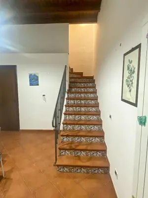 a stairway in a building with wooden steps at La discesa di San Giuseppe in Termini Imerese