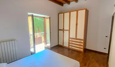 an empty room with a bed and a window at La discesa di San Giuseppe in Termini Imerese