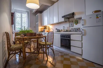 a kitchen with a table and chairs and a refrigerator at Palermo 3 bedrooms apartment historic center in Palermo