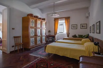 a bedroom with two beds and a chandelier at Palermo 3 bedrooms apartment historic center in Palermo