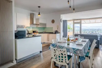 a kitchen and dining room with a table and chairs at Lollo's Terrace Panoramic View in Palermo