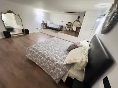 a bedroom with a bed and a mirror at Siloe Apartment Palermo in Palermo