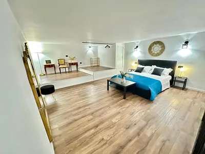 a bedroom with a blue bed and a living room at Siloe Apartment Palermo in Palermo