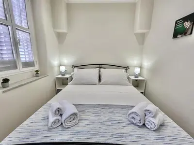 a bedroom with a bed with towels on it at Casa Esterù -Centro storico di Palermo- in Palermo