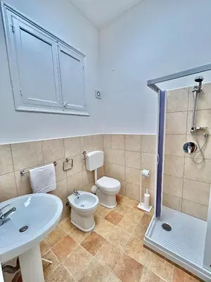 a bathroom with a toilet and a sink and a shower at Casa Esterù -Centro storico di Palermo- in Palermo