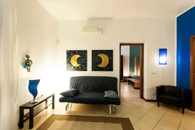 a living room with a couch and a chair at Al Vicolo Palermo in Palermo