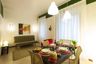 a living room with a bed and a chair at Al Vicolo Palermo in Palermo