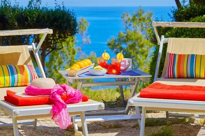 a table with a tray of food and a table with chairs at Villa Ginestra - Scopello-Villas in Scopello