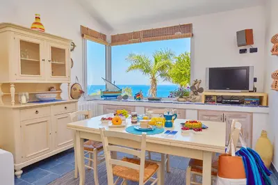 a kitchen with a table with food on it at Villa Ginestra - Scopello-Villas in Scopello