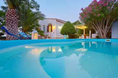 a swimming pool in front of a house at Villa Ginestra - Scopello-Villas in Scopello