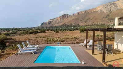 a pool on a deck with a mountain in the background at Villa with Sea view Private Pool in Terrasini
