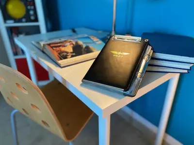 a table with a book and a bag on it at La Casa dell'Aviatore in Boccadifalco