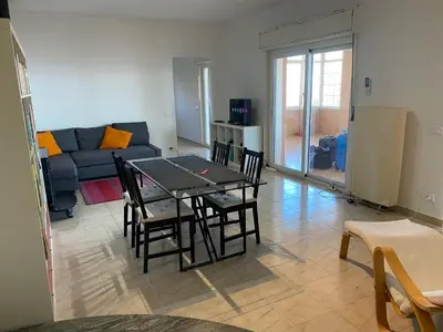 a living room with a table and chairs and a couch at La Casa dell'Aviatore in Boccadifalco
